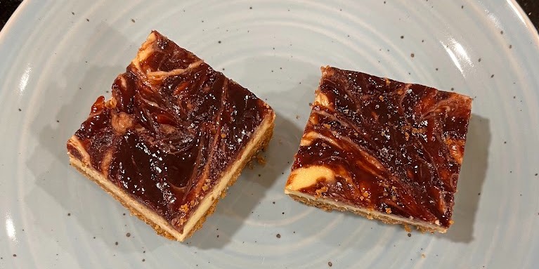 Cheesecake bars with swirled fruit toppings